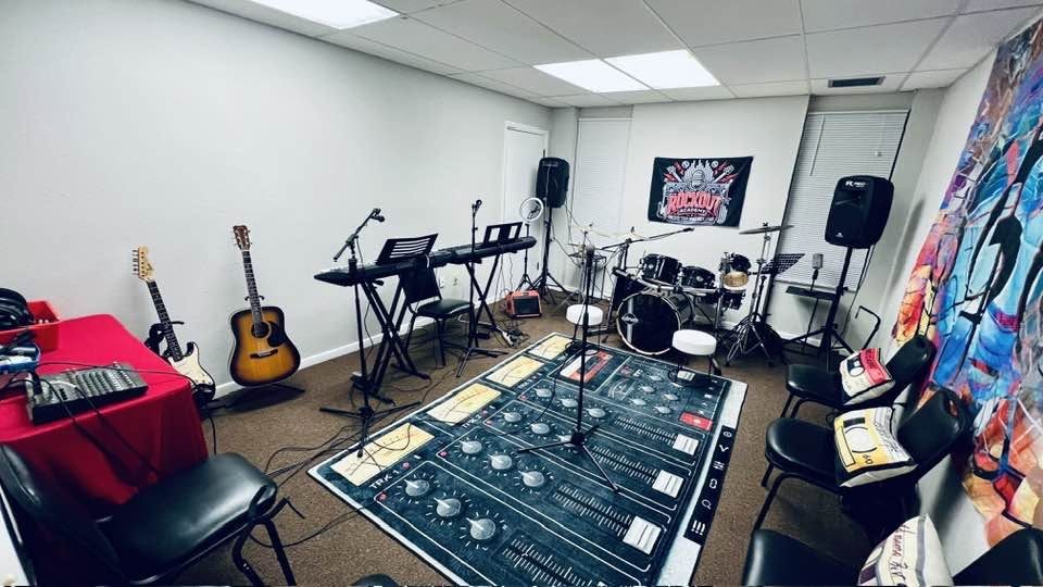 The band room at Rock Out Academy, set up with drums, keyboards and guitars